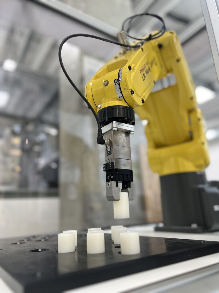 FANUC industrial robotic arm in a production cell